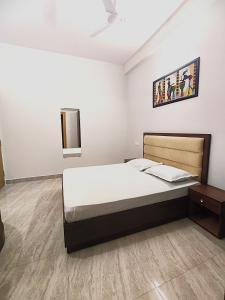 a bedroom with a bed and a wooden floor at S P Residency in Lucknow