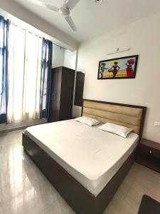 a bedroom with a large bed in a room at S P Residency in Lucknow +2 photos
