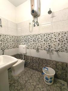 a bathroom with a toilet and a sink at S P Residency in Lucknow