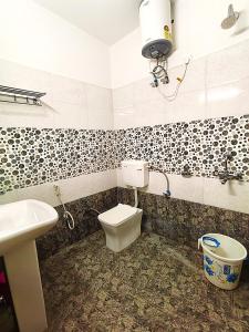 a bathroom with a toilet and a sink at S P Residency in Lucknow