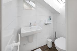 a white bathroom with a sink and a toilet at schöne Whg. 3 Schlafzimmer Balkon in Lüdenscheid +23 photos