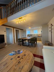 a living room with a wooden table and a dining room at Vue incroyable Loire et Chateau in Amboise