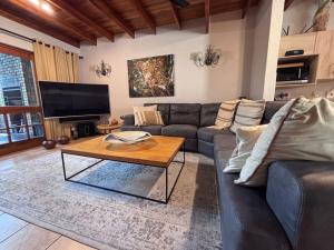 a living room with a couch and a coffee table at Hazyview Kruger Lodge in Hazyview