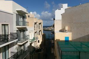 a view of the water from between buildings at Sea Steps Marsalforn in Marsalforn