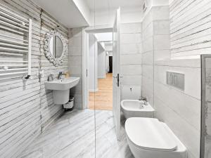 a white bathroom with a toilet and a sink at Abel 27 Residence in Bacău