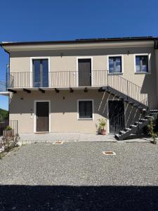 a large building with a balcony and stairs on it at NessunConfine Casa Sara in Santa Giuletta +32 photos