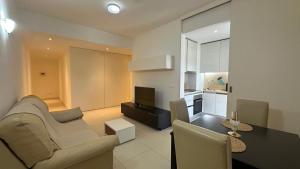 a living room with a couch and a table at Edifício Kings Tower T2-02 in Luanda