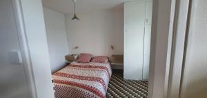 a room with two beds with red and white sheets at Gîte des pêcheurs, Gorges du Tarn in Mostuéjouls