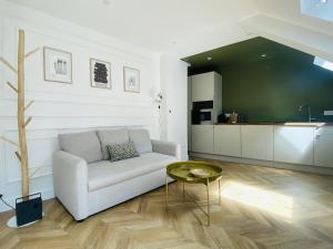 a living room with a couch and a table at La PARENTHESE RUTHENOISE in Rodez +17 photos