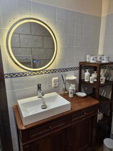 a bathroom with a sink and a mirror at Le port des Chalands meublé de tourisme 3 étoiles in Saint-Georges-sur-Cher