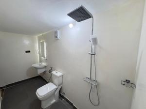 a bathroom with a shower and a toilet and a sink at TravelLodge Eco in Arugam Bay +70 photos