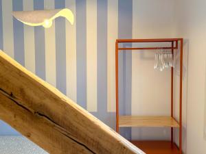 a staircase with a mirror and blue and white stripes at Studio cosy proche des Thermes in Royat