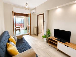 a living room with a couch and a flat screen tv at Appartamento Turistico Monterotondo in Monterotondo