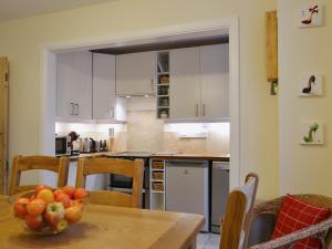 a kitchen with a table with a bowl of fruit on it at Beny Cot in Keswick