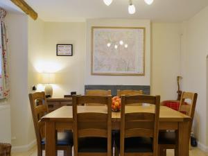 a dining room with a wooden table and chairs at Beny Cot in Keswick