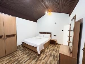 a bedroom with a bed in a room at TravelLodge Eco in Arugam Bay