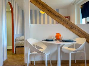 a dining room with a white table and chairs at Studio cosy proche des Thermes in Royat