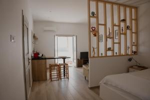 a bedroom with a bed and a desk and a table at The Lighthouse Sunset View Suites in Akrotiri