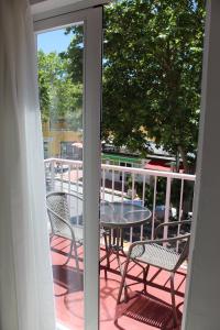 a patio with a table and chairs on a balcony at Villa Palmer in Paguera