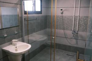 a bathroom with a shower and a sink at Shiyue Homestay in Zhuangwei