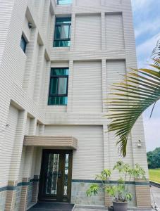 a large white building with a front door at Shiyue Homestay in Zhuangwei