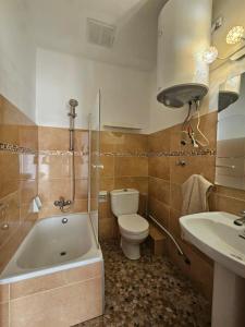 a bathroom with a tub and a toilet and a sink at Villa Palmer in Paguera +65 photos