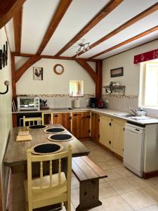 a kitchen with a table and a stove top oven at Chez Jallot - Lower Gite in Vidaillat +32 photos