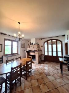 a dining room with a table and a fireplace at Le Corolle in Montepulciano