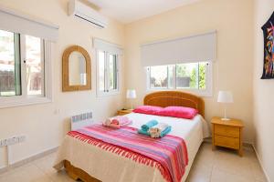 a bedroom with a bed with two stuffed animals on it at Unique Beach Luxurious Villas in Ayia Napa +34 photos