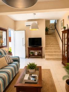 a living room with a couch and a tv at Unique Beach Luxurious Villas in Ayia Napa
