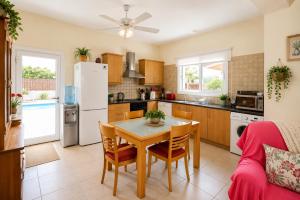 a kitchen and dining room with a table and chairs at Unique Beach Luxurious Villas in Ayia Napa