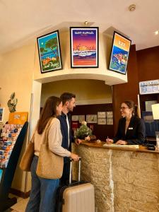 a group of people standing at a counter in a store at Les Palmiers in Fréjus