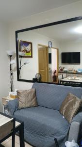 a blue couch in a living room with a large mirror at Keyspace condotel in Piapi
