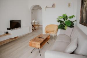 a living room with a couch and a coffee table at The Lighthouse Sunset View Suites in Akrotiri