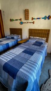 two beds in a room with blue and white at Casa Monã in Maceio +23 photos