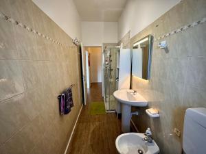 a bathroom with a sink and a toilet and a mirror at Dora Flow in Banchette +8 photos