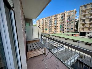 a balcony with a bench on top of a building at Dora Flow in Banchette
