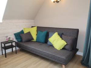 a couch with colorful pillows in a living room at Holiday Home Les Blés by Interhome in Plozévet