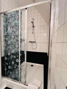 a shower with a glass door in a bathroom at het Binnenhuis in Workum +33 photos