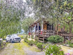 a car parked in front of a wooden house at Holiday Home Le Terrazze del Geco Bungalow B - SLR301 by Interhome in San Lorenzo al Mare