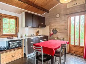 a kitchen with a table with a red table cloth at Holiday Home Le Terrazze del Geco Bungalow A - SLR300 by Interhome in San Lorenzo al Mare