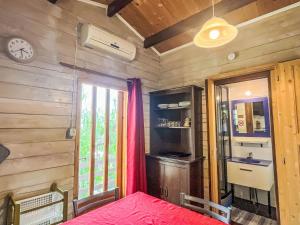 a bedroom with a bed and a clock on the wall at Holiday Home Le Terrazze del Geco Bungalow A - SLR300 by Interhome in San Lorenzo al Mare +56 photos