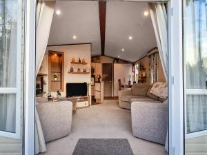 a living room with a couch and a tv at 5 Pine Rise in Poole
