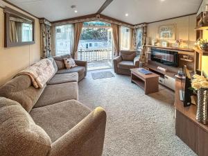 a living room with a couch and a tv at 5 Pine Rise in Poole