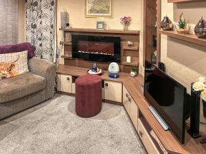 a living room with a couch and a television at 5 Pine Rise in Poole