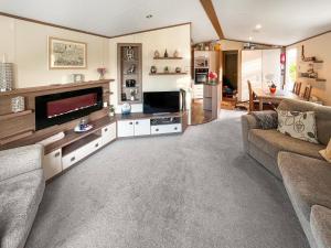 a living room with a couch and a television at 5 Pine Rise in Poole +11 photos
