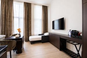 a hotel room with a bed and a television at GemStay Antwerp in Antwerp