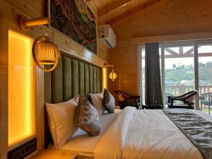 a bedroom with a bed in a wooden cabin at The Walnut Homes- Luxury Pine Cottages in Bhīm Tāl