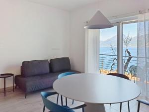 a living room with a table and a couch at Apartment La Maison Blanche-1 by Interhome in Brenzone sul Garda