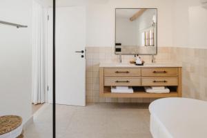 a bathroom with a sink and a mirror at Rickety Bridge Estate in Franschhoek